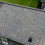 Aerial view of hail damage to an asphalt shingle roof on Colorado home needing roof replacement