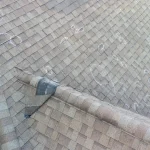 Asphalt shingle roof with chalk circles marking hail damage impacts during a storm damage inspection.
