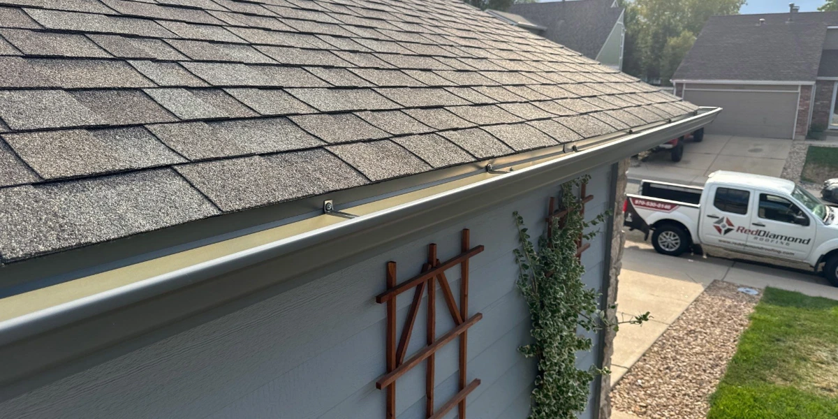 Newly installed asphalt shingle roof and gutter on a Denver, Colorado home by Red Diamond Roofing